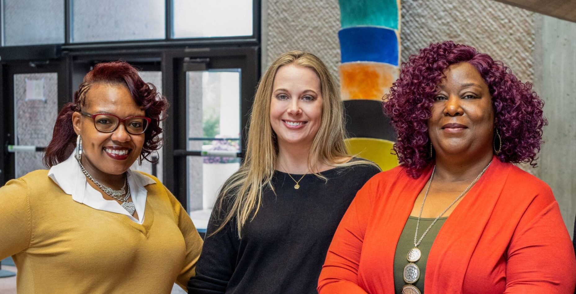 The Gifford staff pose together smiling at the camera at the Everson Museum. From left to right - Sheena Solomon, Lindsay McClung, and Sheria Walker,