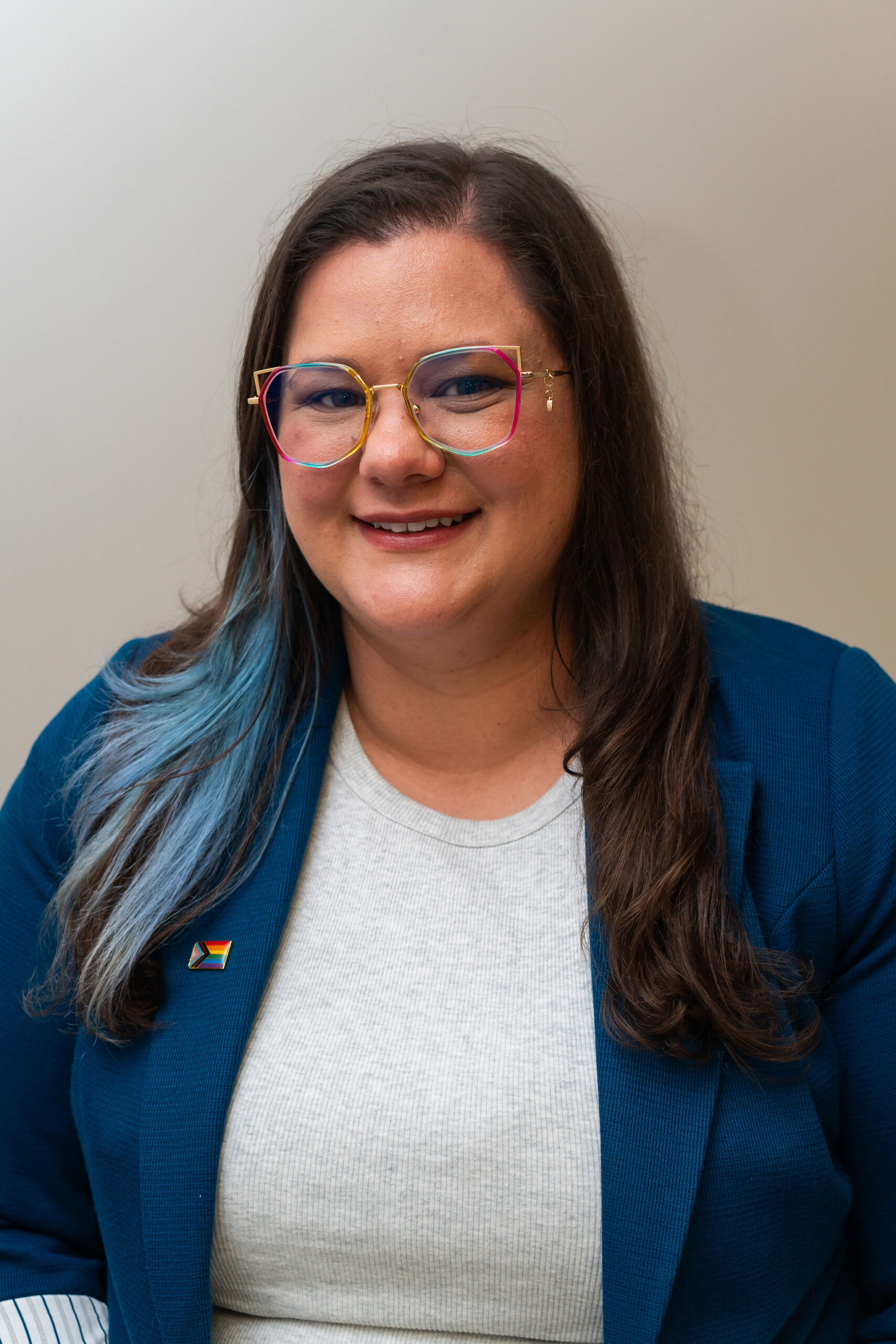 Katlyn Bauer professional headshot with gray shirt and blue blazer.