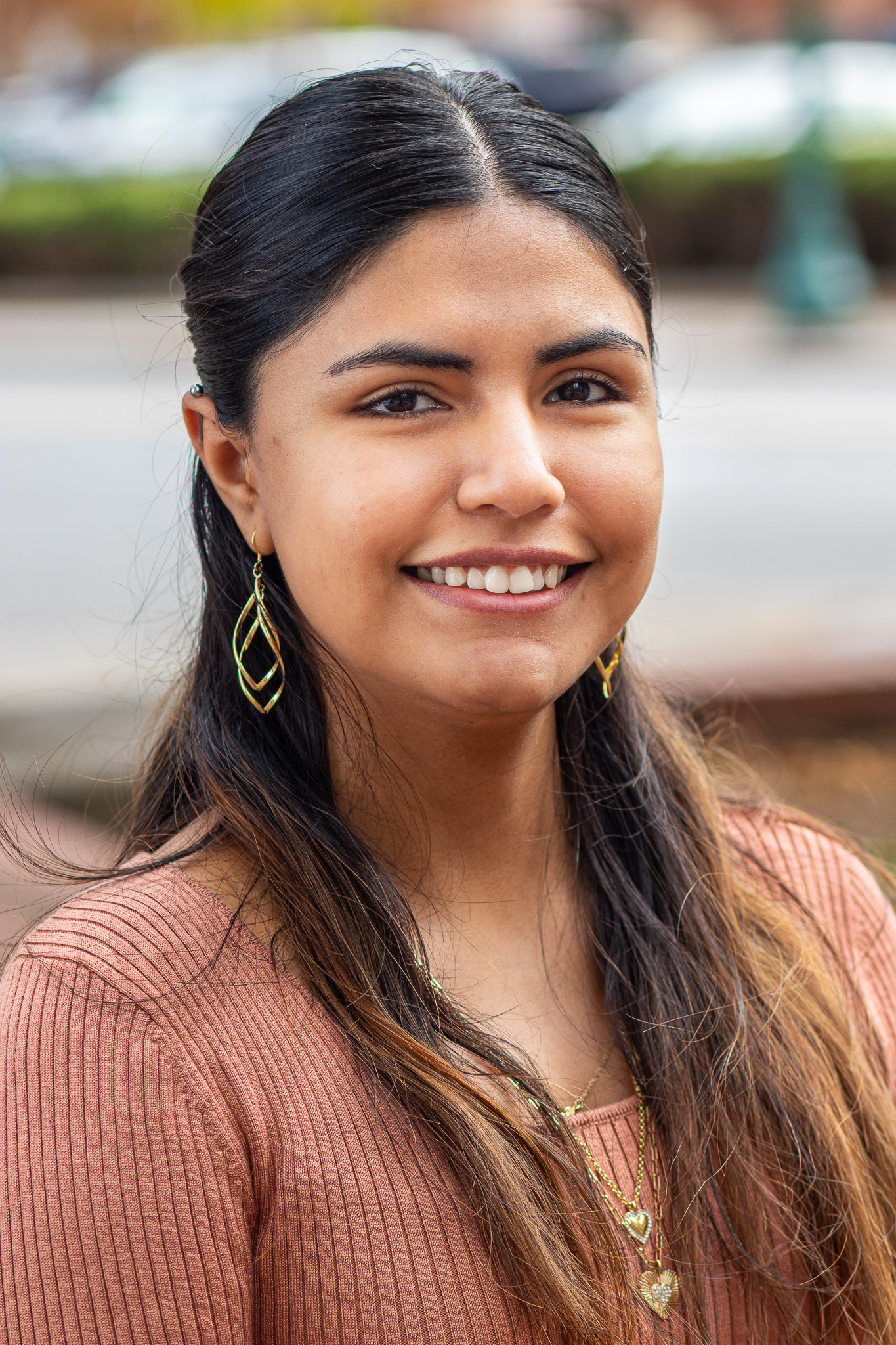 Lizbeth Ortega-Bates professional headshot with mauve ribbed top