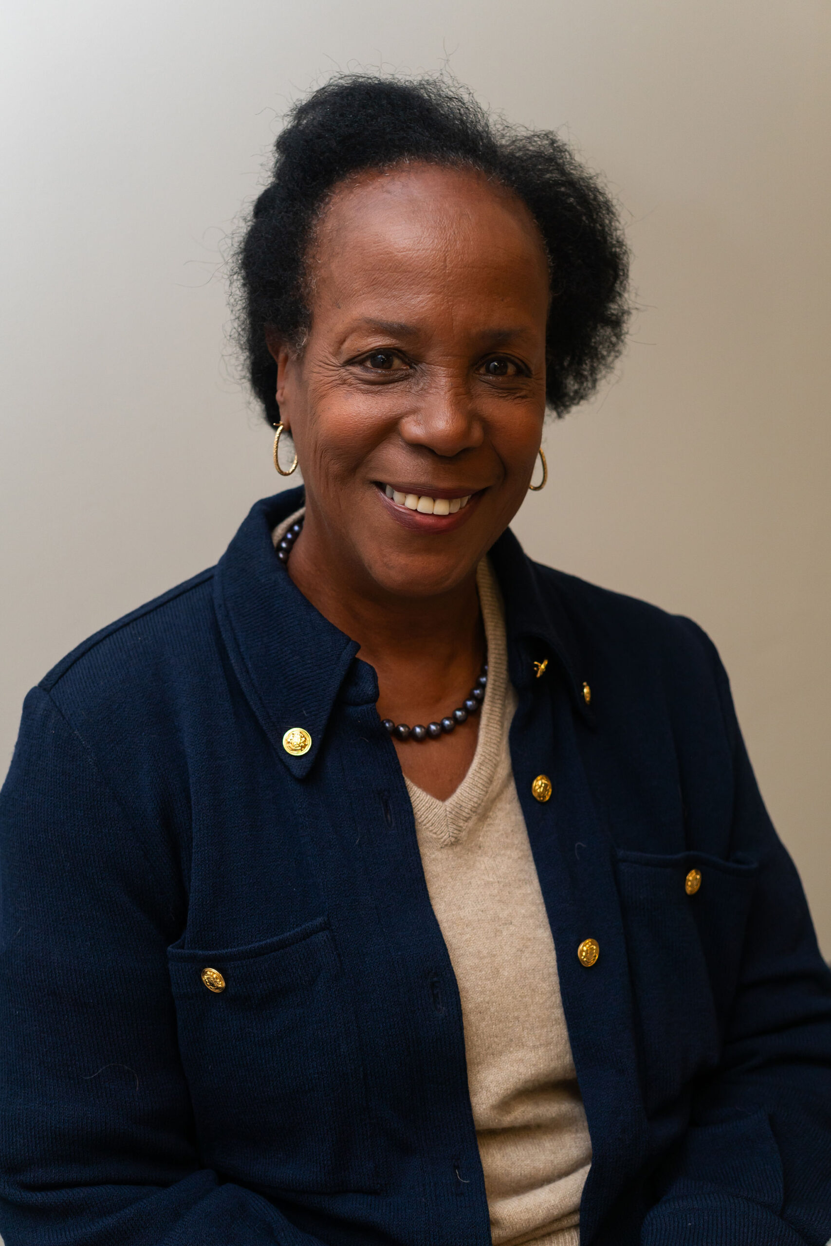 Shelly Gardner professional headshot with cream sweater and black jacket