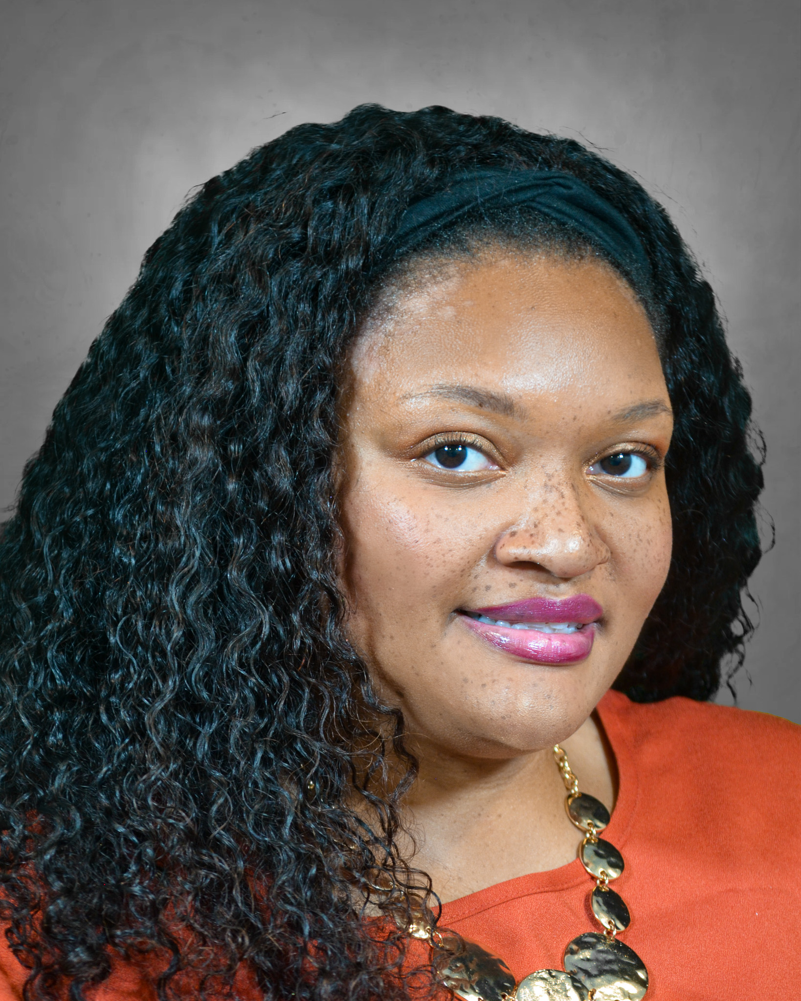 Terrian Garvis professional headshot with black shirt that says Black Men Smile