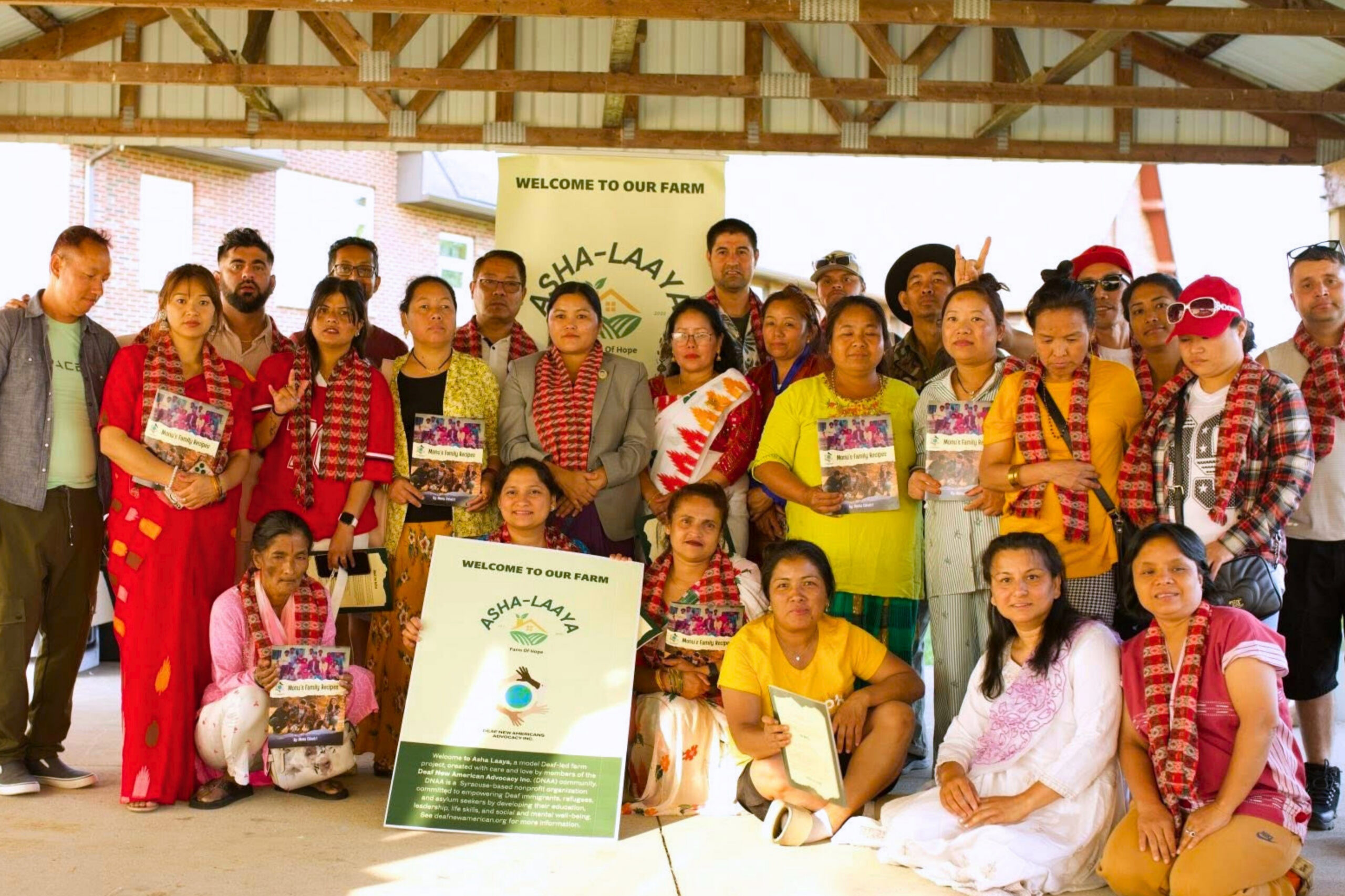A large group photo of participants and volunteers who are associated with the organization, Deaf New American Advocacy (DNAA)